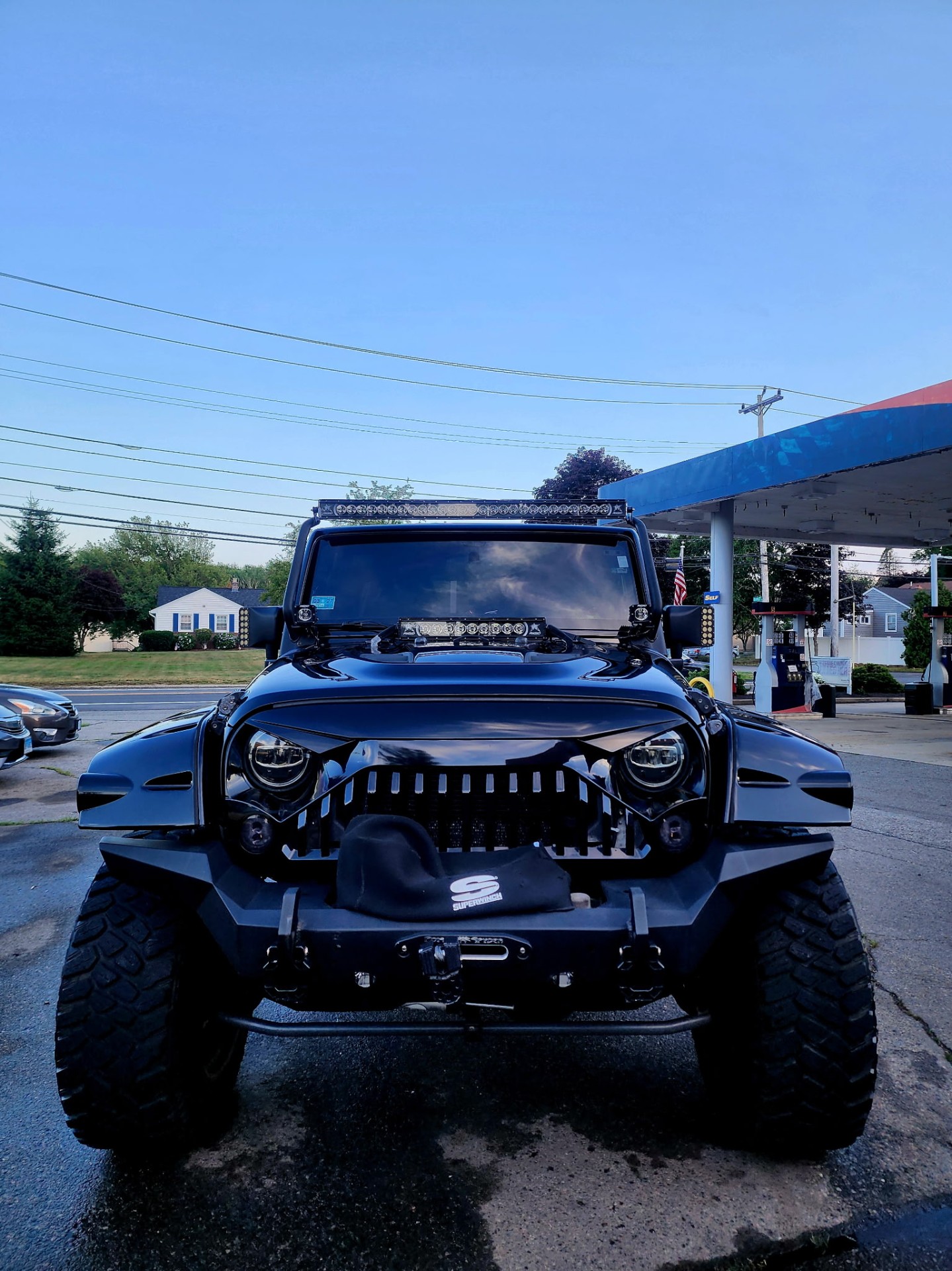 Blacked-out lifted Jeep Wrangler front after detail