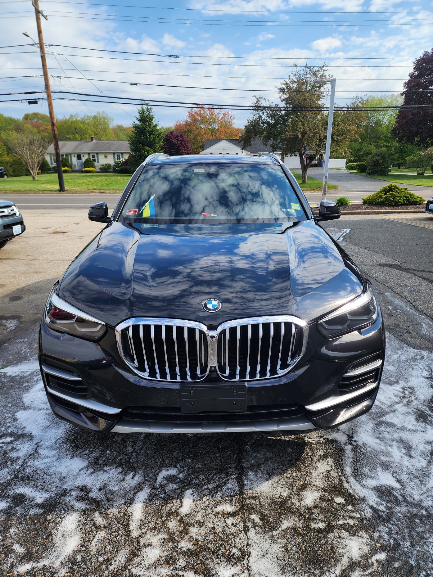 Black BMW X5 during foam wash